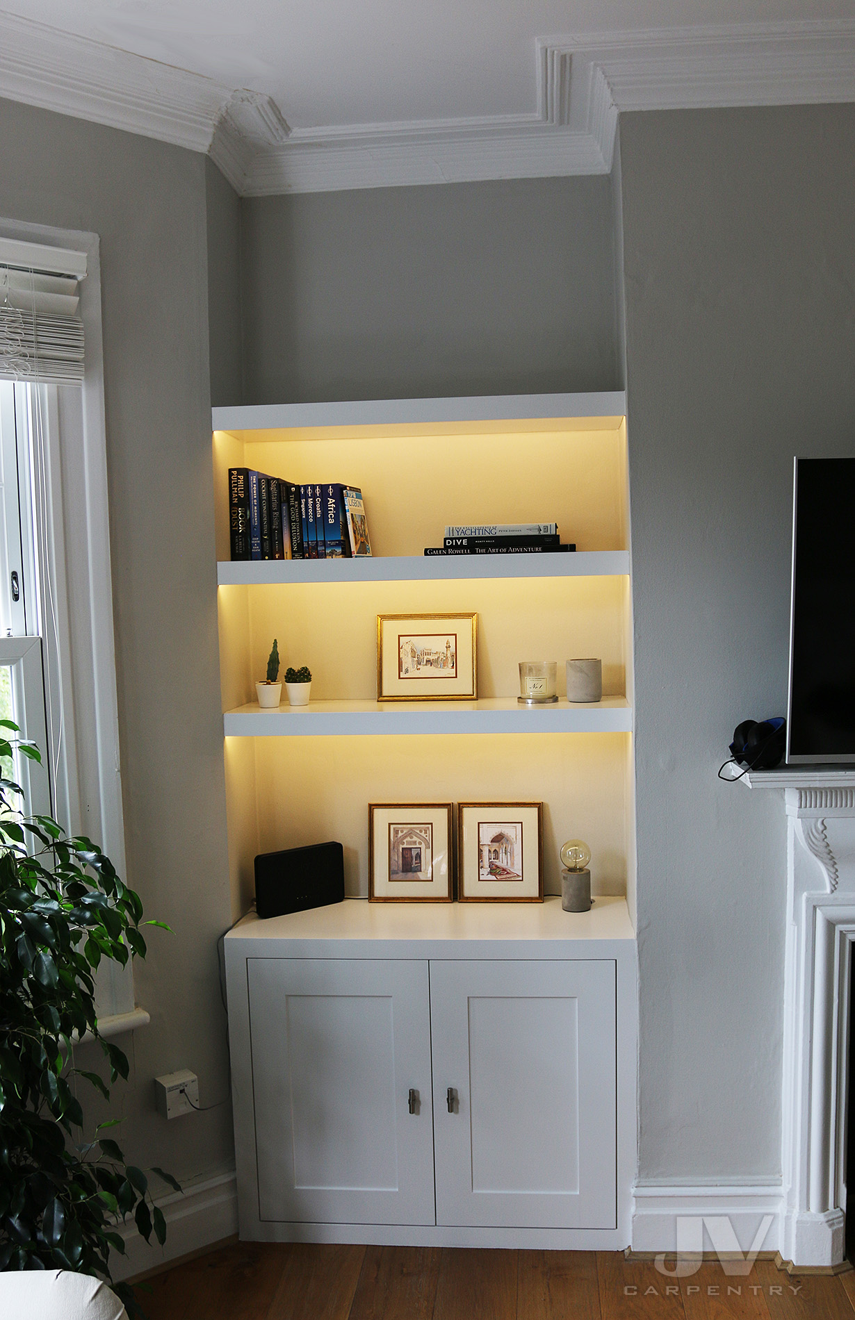 alcove shelving with lights and cabinet at the bottom LHS