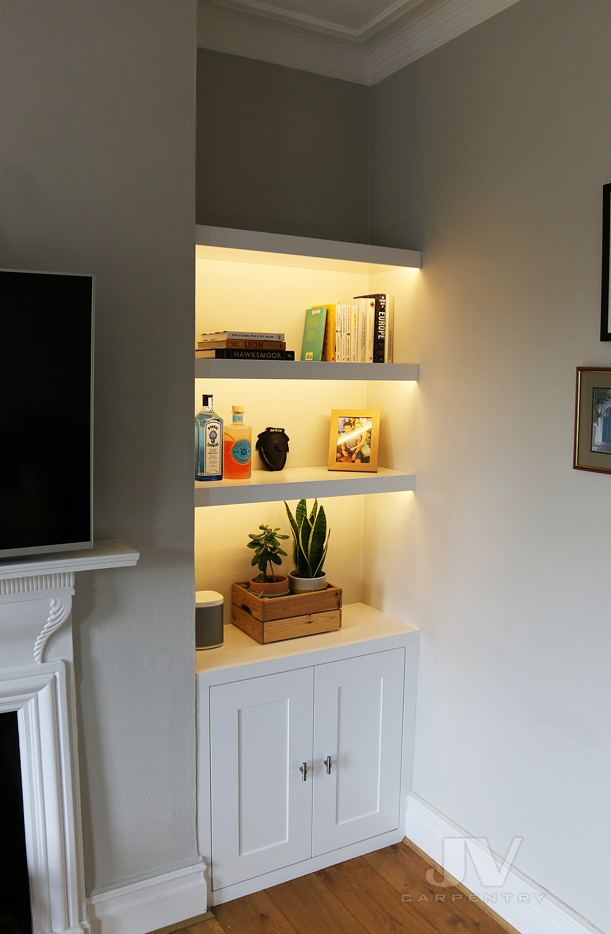 alcove floating shelving with lights and cabinet at the bottom RHS