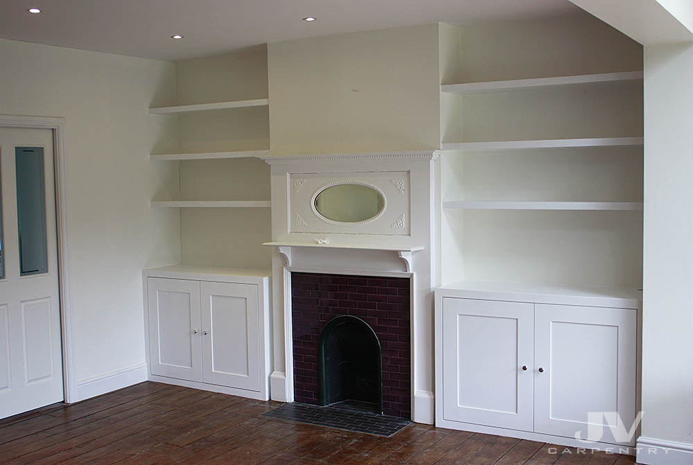 A pair of bespoke alcove cabinets with floating shelves