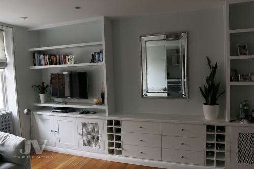 built-in bespoke shelves and cupboards with TV