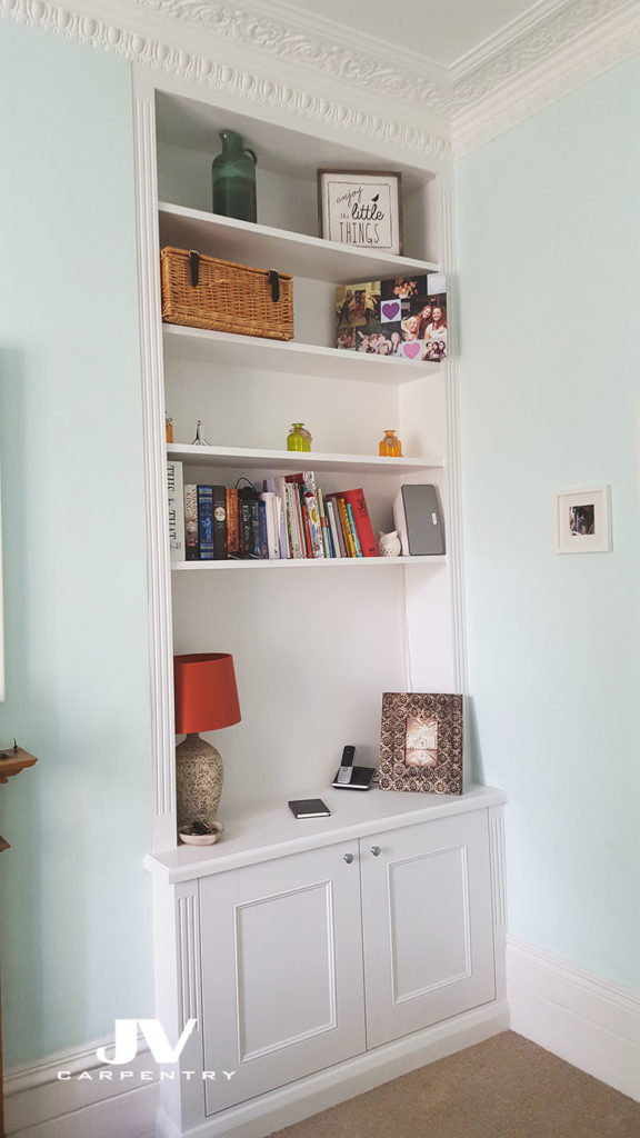 Alcove cupboards with shelves. Alcove bookshelves in livingroom traditional style. Hand painted white eggshell finish