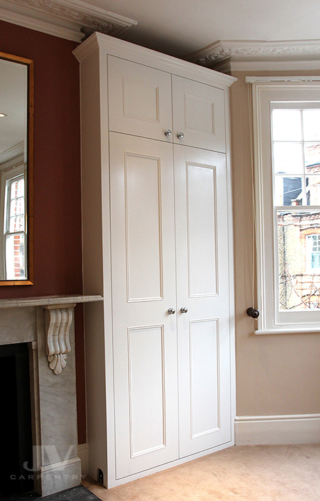 Alcove fitted wardrobe ideas for you. Picture showing made-to-measure traditional wardrobe fitted into an alcove of the London property