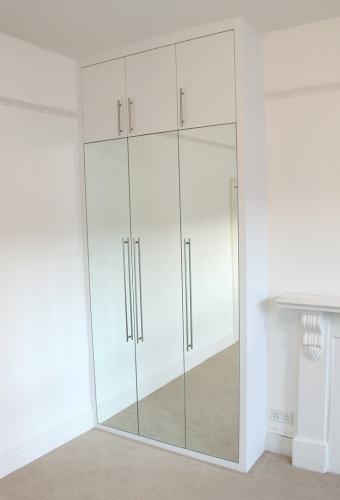 fitted wardrobe with flush mirrored doors