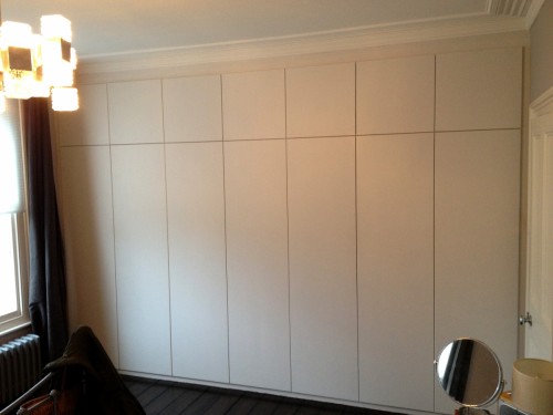 Fitted wardrobe with plain push to open doors