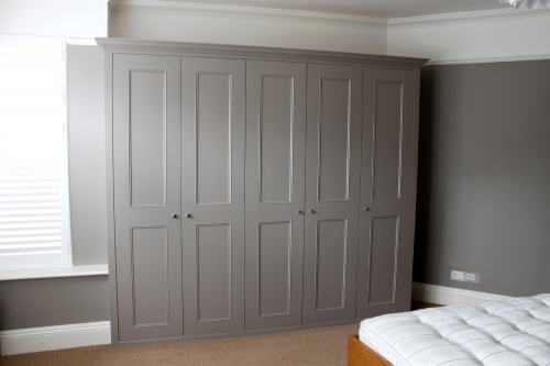 Fitted wardrobe painted grey colour with shaker beaded doors