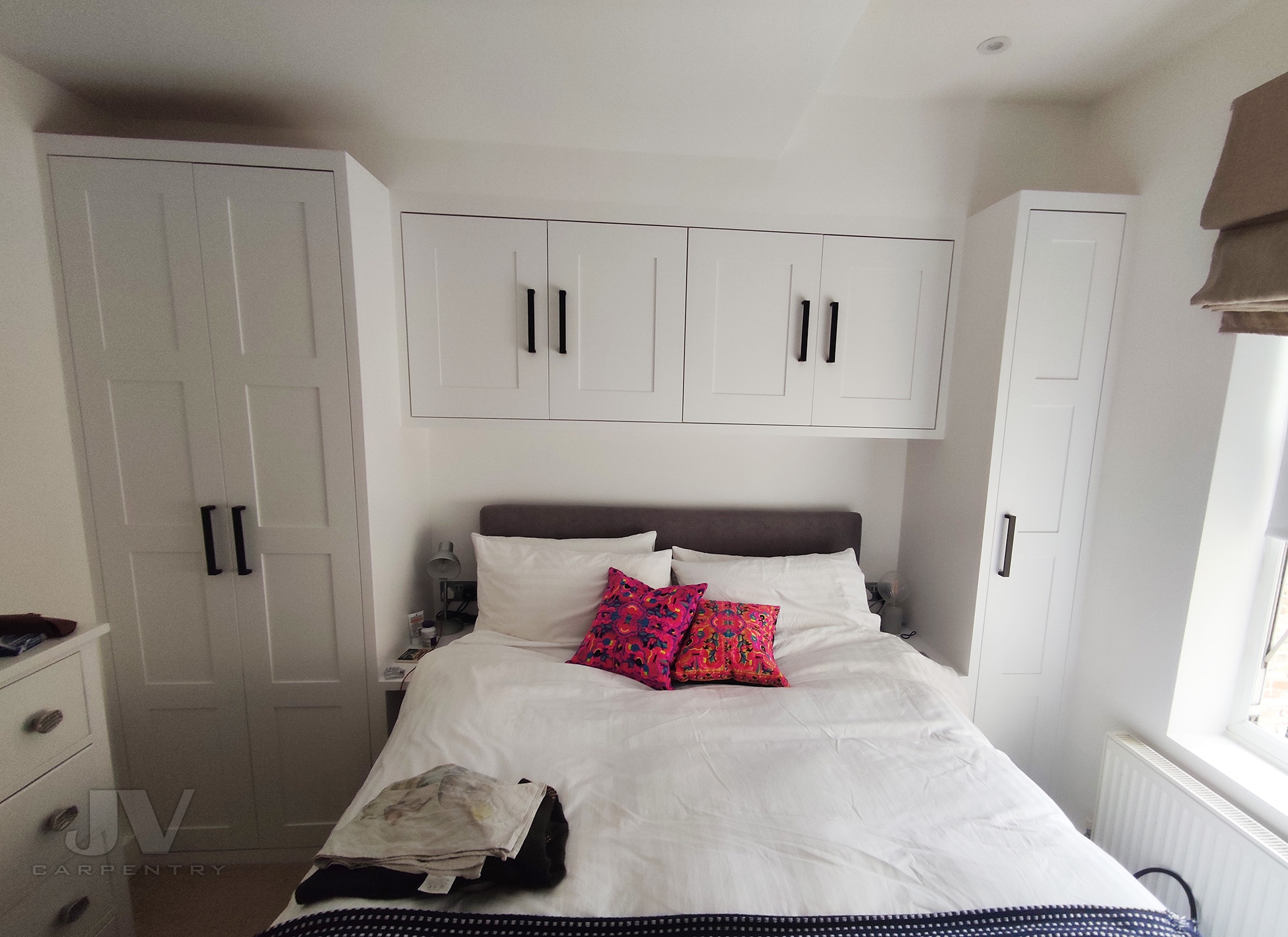 small bedroom wardrobe with over bed storage