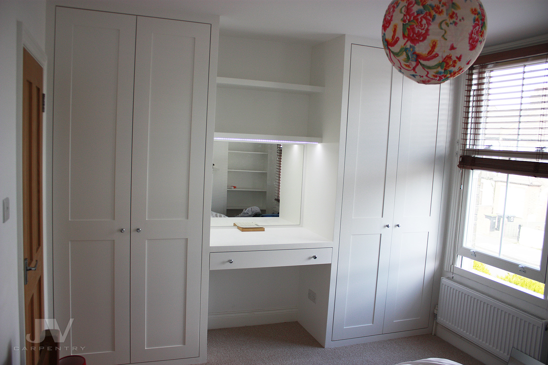 Dressing table fitted between two wardrobes