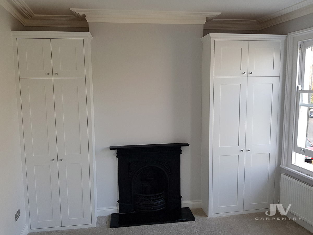 two alcove fitted wardrobes either side of the fireplace