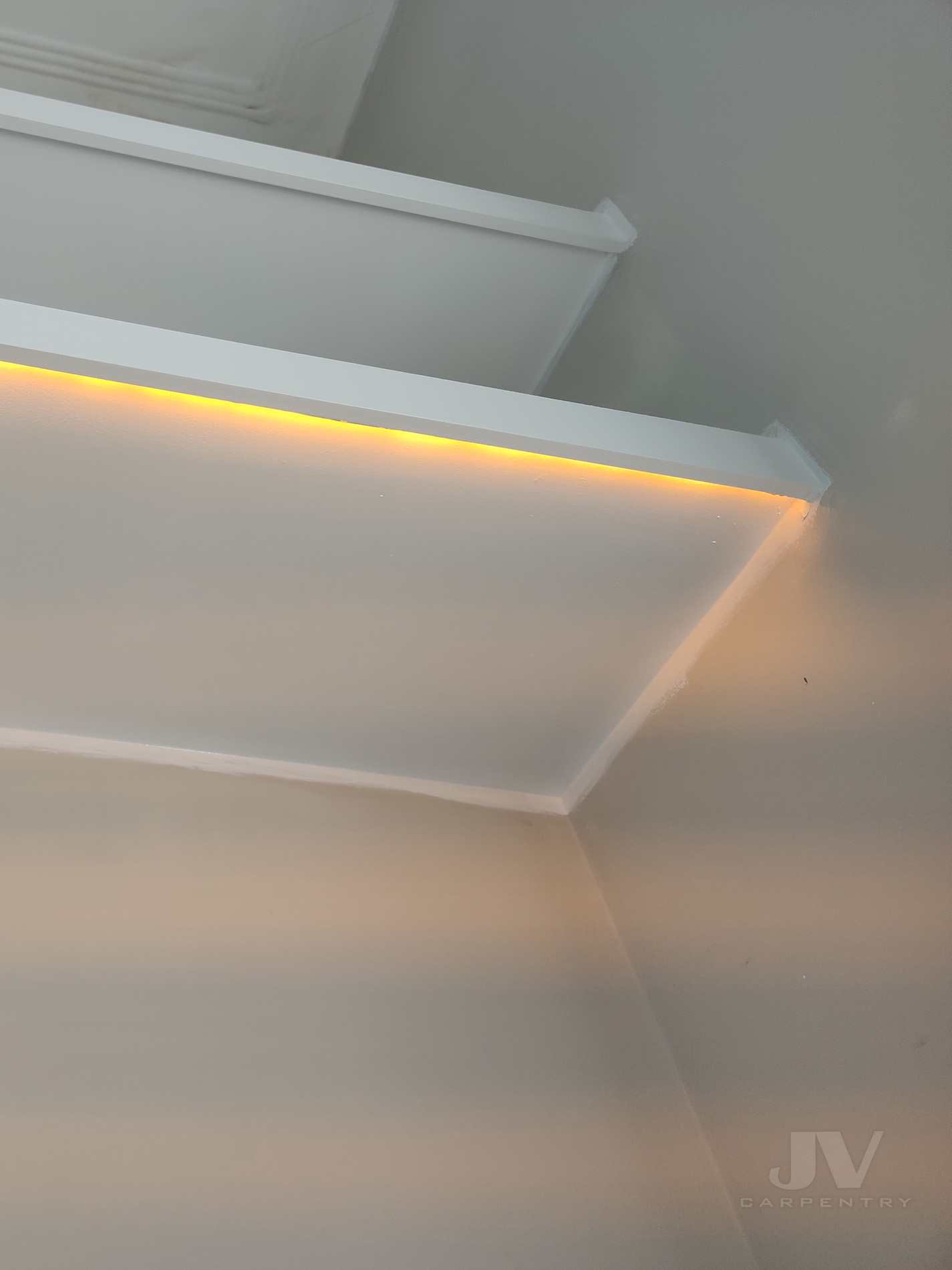 led light underneath floating shelf in alcove
